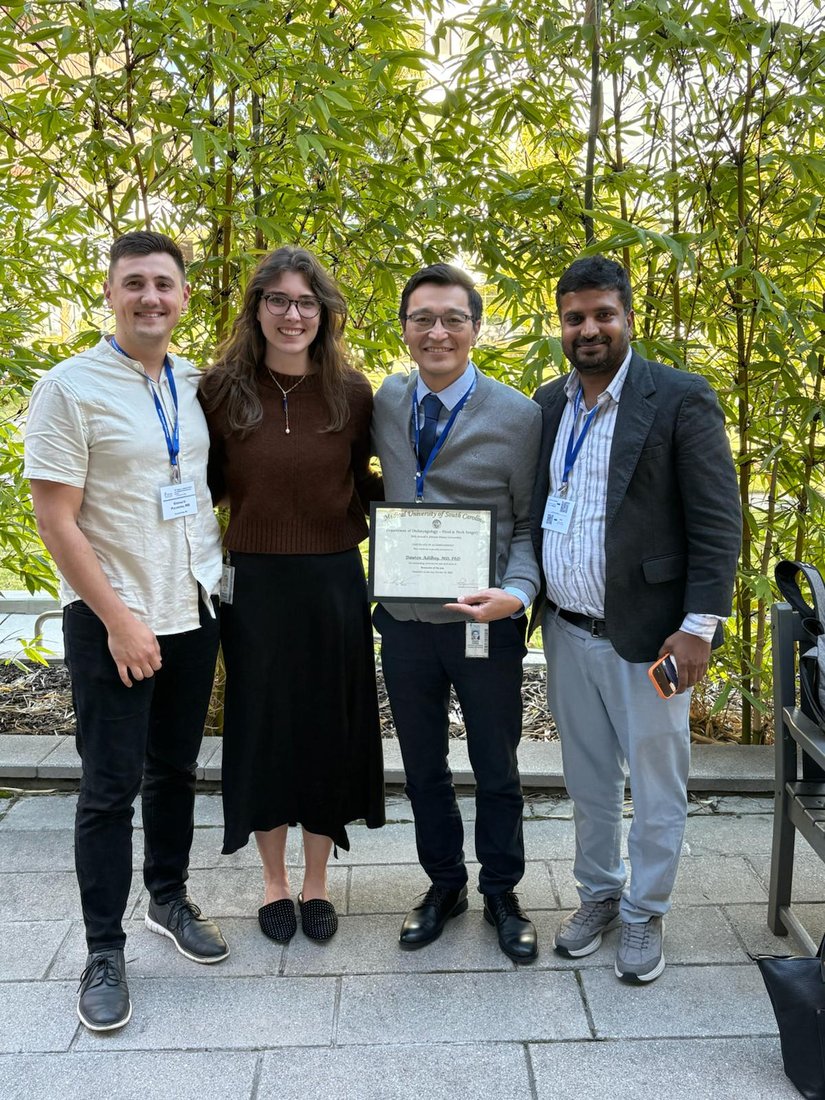The Adilbay Lab team celebrating the award