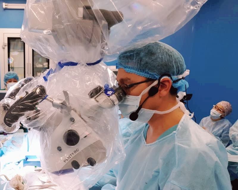Dr. Adilbay performing microsurgery